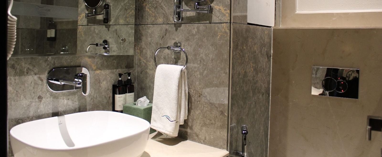 A bathroom featuring washbasin and a face mirror at BluSalzz Residence, Amritsar.